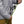 Person wearing a Black Diamond jacket using a belay device with a green climbing rope