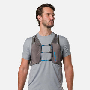 Man wearing a grey Nathan hydration vest over a grey t-shirt