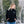 Woman wearing a black Go! Heat zip up hoodie with blue jeans in a snowy forest