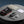 ActionHeat rechargeable hand warmer with box, charging cable, carry pouch, and user manual on a grey surface