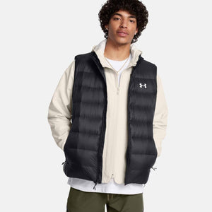 Man wearing a black Under Armour puffer vest over a beige zip up jacket
