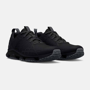 Under Armour black athletic training shoes with mesh upper and textured rubber sole