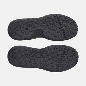 Under Armour black shoe outsoles with textured lug pattern