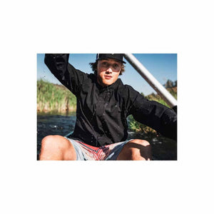 Man wearing Under Armour black jacket kayaking on water