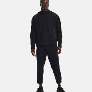 Man wearing Under Armour black hooded windbreaker and matching track pants