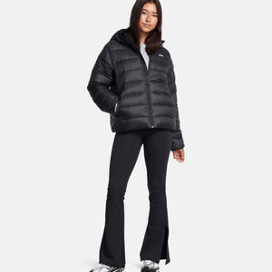 Woman wearing a black Under Armour hooded puffer jacket and black leggings