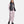 Under Armour model wearing a black puffer vest over a light pink long sleeve shirt and matching cargo joggers