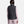 Back view of a person wearing a black Under Armour Storm puffer vest over a light pink long sleeve shirt