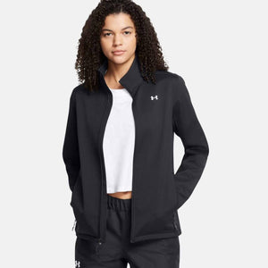 Woman wearing a black Under Armour zip up jacket over a white shirt