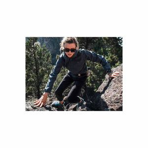 Woman wearing Under Armour jacket climbing a rocky trail