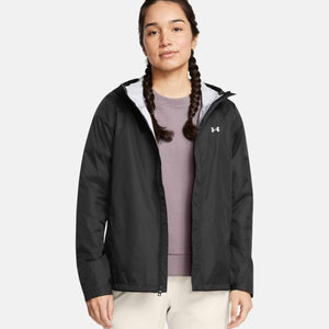 Woman wearing a black Under Armour hooded windbreaker jacket