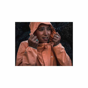 Person wearing an Under Armour peach rain jacket with hood up in the rain