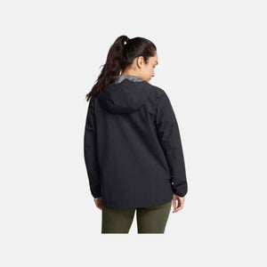 Back view of a person wearing a black Under Armour hooded jacket