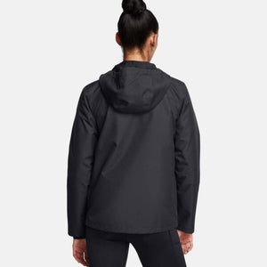 Back view of a person wearing a black Under Armour hooded jacket