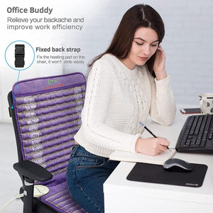 Woman sitting at desk using a purple UTK Technology heating pad with a fixed back strap on her office chair
