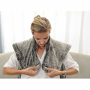 Woman wearing a grey faux fur UTK Technology heating pad around her neck