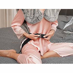Person wearing a UTK Technology heating pad with a black strap around their waist