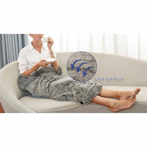 Person sitting on a couch using a grey UTK Technology ultra soft plush heating pad