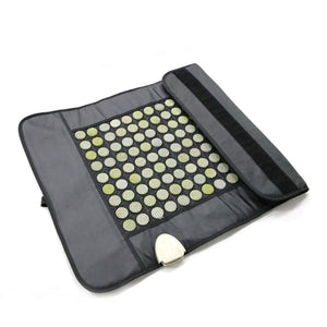UTK Technology heating pad with embedded jade stones on a black fabric mat