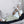 Woman sitting on a sofa using a UTK Technology infrared heating mat