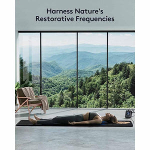 Person lying on a UTK Technology infrared mat in a room with mountain views