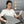 Woman using a grey electric heating pad with icons for eco-friendly materials safety circuit and waterproof design