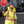 Pioneer traffic controller wearing high visibility shirt and hard hat with neck shade holding a stop sign