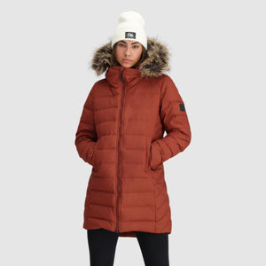Outdoor Research women's rust colored puffer parka with faux fur hood and white beanie