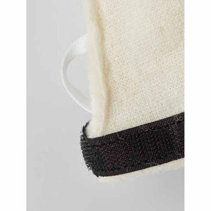 Close up of Hestra glove cuff with white fabric and black velcro strap