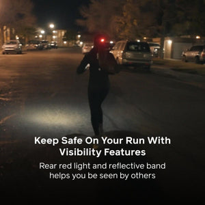 Runner wearing gear with a rear red light and reflective band at night