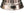 Close up of a silver propane heater base with a black control knob and gas inlet valve