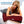 Woman lying on a bed using a Venture Heat infrared heating pad