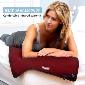 Woman lying on a bed using a Venture Heat infrared heating pad