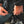 Hands connecting a Venture Heat power cable to a motorcycle