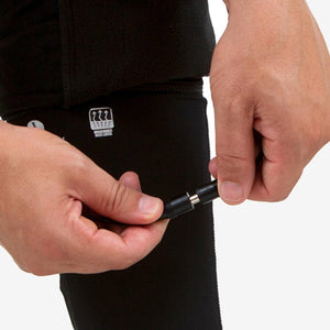 Hands connecting power cable to Venture Heat base layer garment