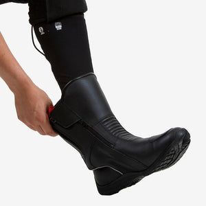 Person putting on a Venture Heat black leather motorcycle boot