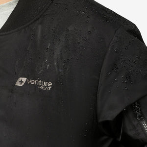 Close up of water droplets on black Venture Heat jacket fabric
