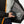 Person holding a Venture Heat power bank inside the inner pocket of a black heated jacket