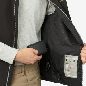 Person placing a Venture Heat battery pack into the interior pocket of a heated vest