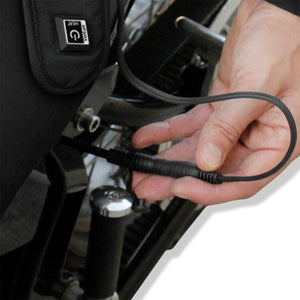 Hand connecting a Venture heated gear power cable to a motorcycle battery harness