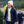 Woman wearing Venture Heat black puffer jacket and pink beanie hiking outdoors with a man