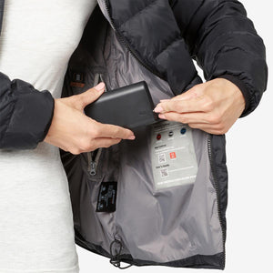 Person connecting battery pack to Venture Heat jacket interior pocket