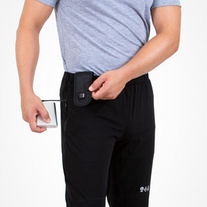 Person connecting a power bank to Venture Heat heated pants