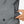 Hand placing Venture Heat battery pack into grey hoodie pocket