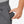 Hand placing a Venture Heat battery pack into the pocket of grey sweatpants
