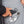 Hand placing Venture Heat battery into interior jacket pocket with heating control instructions label
