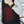 Person wearing a Venture Heat black heated vest with visible red heating elements