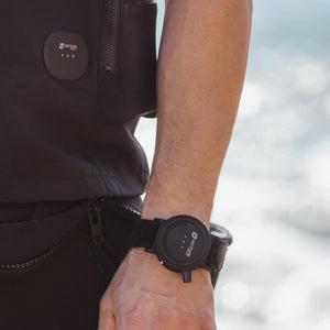 Venture Heat controller worn on wrist and attached to black vest