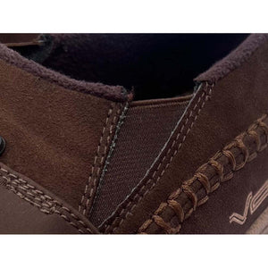 Close up of brown suede slip on shoe with elastic side panel and decorative stitching