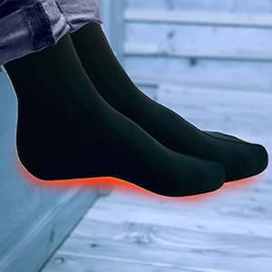 Volt Heat black heated socks with glowing red heating elements on the soles